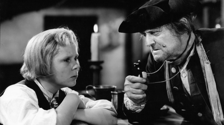Billy Bones shows Jim Hawkins a key in 'Treasure Island' (1934)