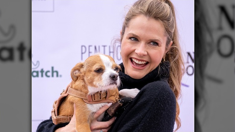Maggie Lawson with a dog on the red carpet
