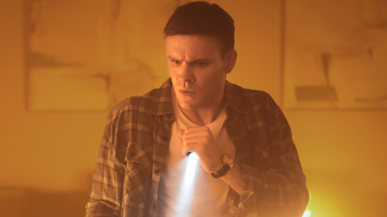 Sean Reagan holding a flashlight in 