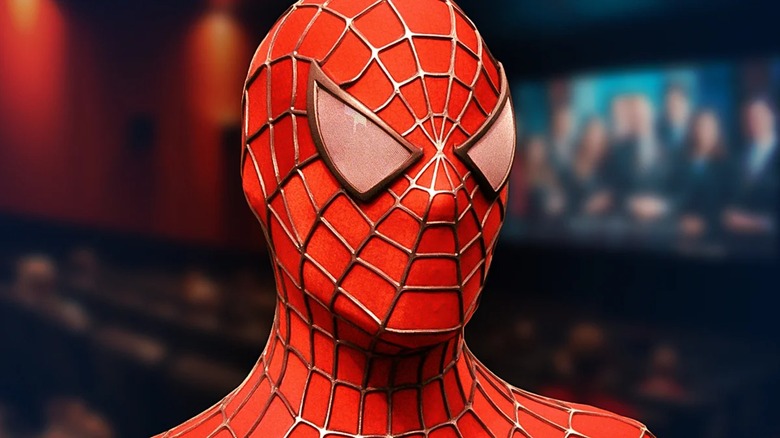 Spider-Man's face in front of an out-of-focus movie theater