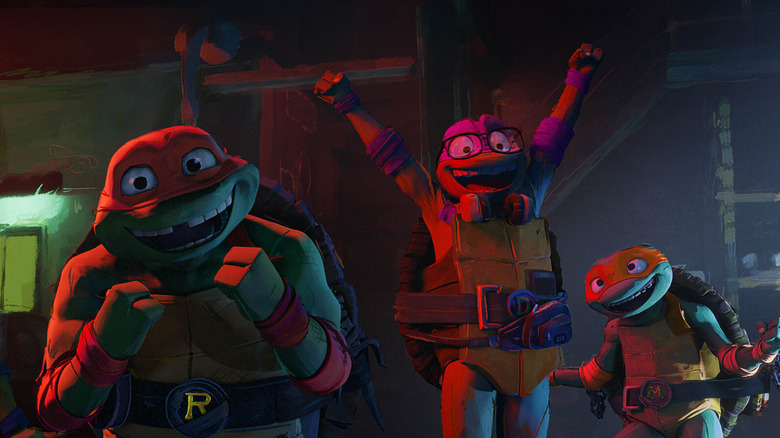 Three of the Ninja Turtles celebrating in Teenage Mutant Ninja Turtles: Mutant Mayhem (2023)