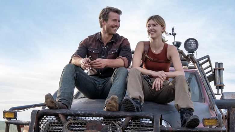 Tyler Owens and Kate Carter chilling on the former character's car in Twisters (2024)