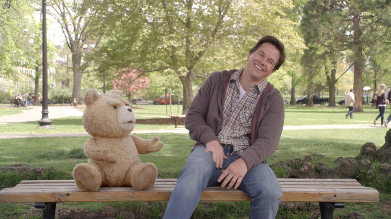 Ted and John laughing together on a park bench in Ted (2012)