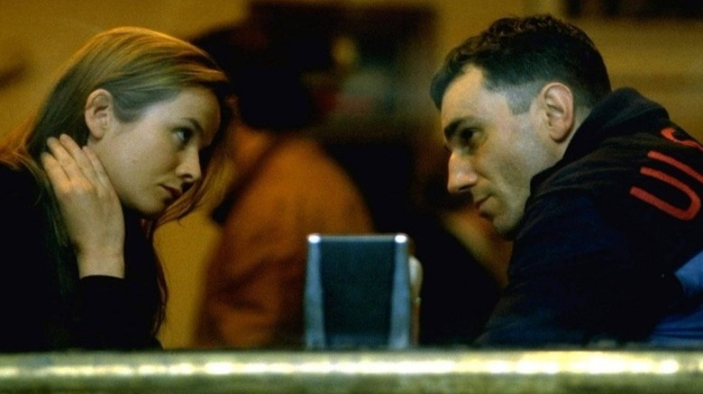 Maggie and Danny looking at each other across a restaurant table in The Boxer (1997)