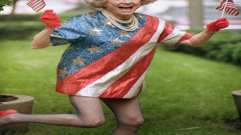 Phyllis Diller holding flags