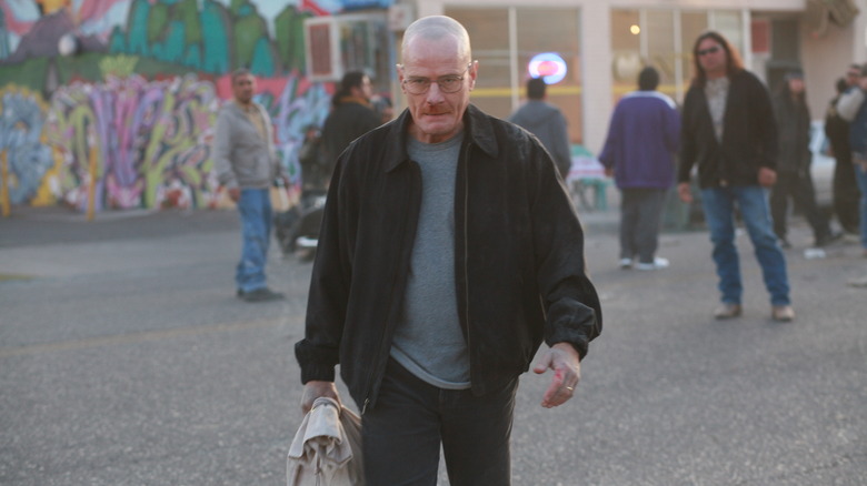 Walter White walking holding bag