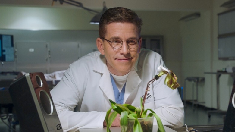 Dr. Jimmy Parker smiles at plant