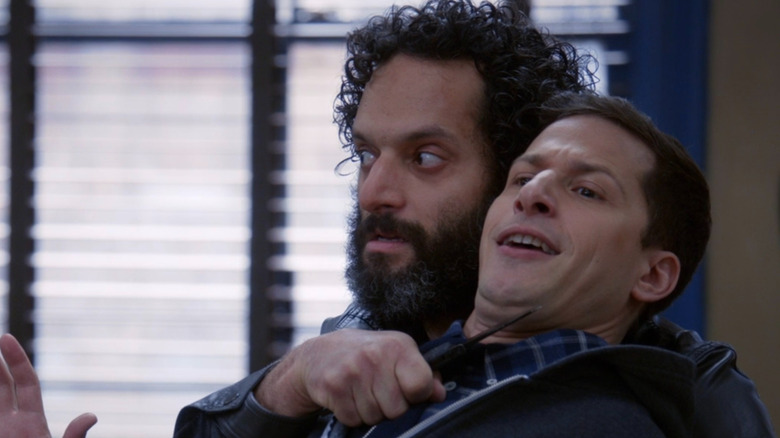 A paranoid Pimento holding a pocket knife to Jake's throat in the precinct