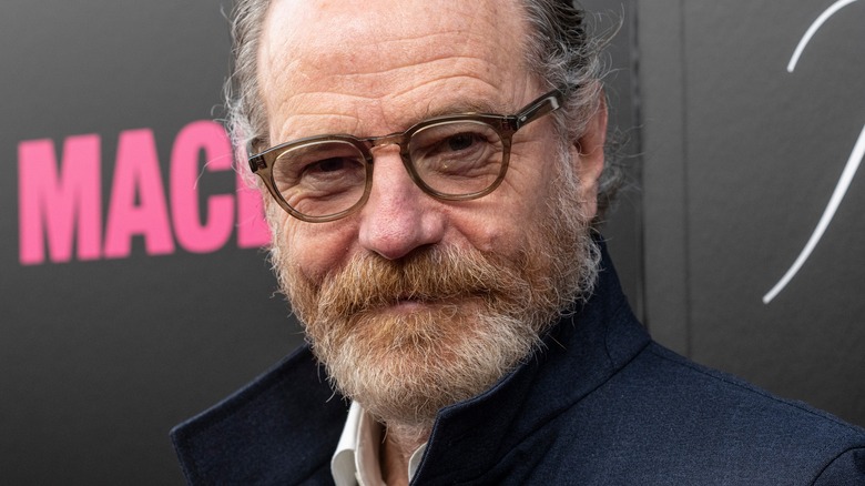 Bryan Cranston glasses navy suit beard