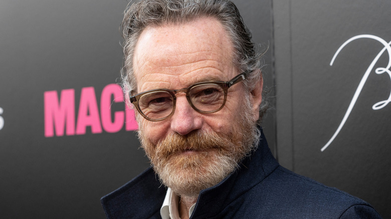 Bryan Cranston glasses navy suit beard