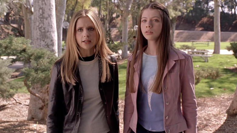 Buffy and her sister Dawn stand near a road