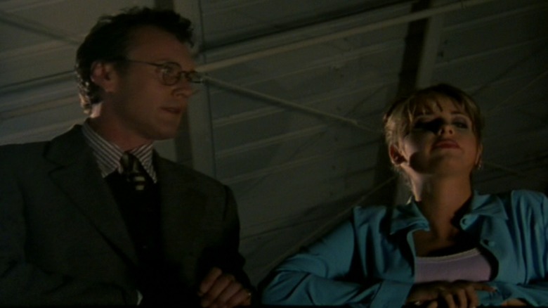 Buffy and Giles standing on a balcony