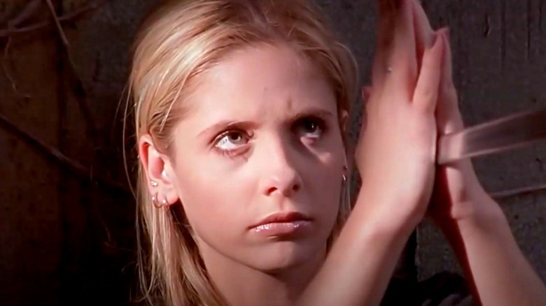 Buffy's hands stop sword in front of her face