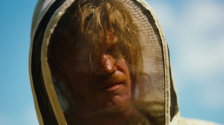 Teddy wears a beekeeper suit in "Bugonia" (2025)
