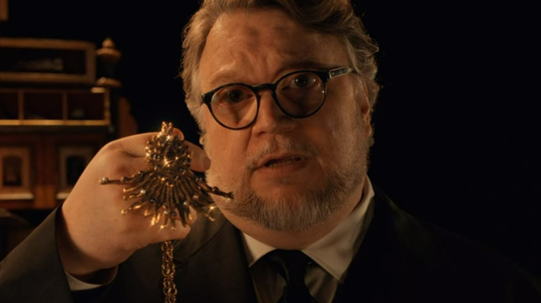 Guillermo del Toro holding a medallion