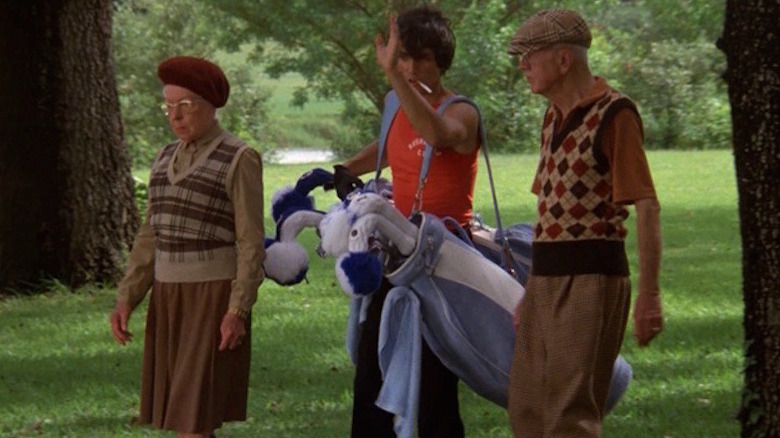 Tony leads Mr. and Mrs. Havercamp across the golf green