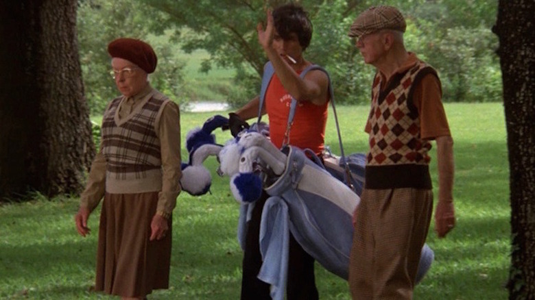 Tony leads Mr. and Mrs. Havercamp across the golf green