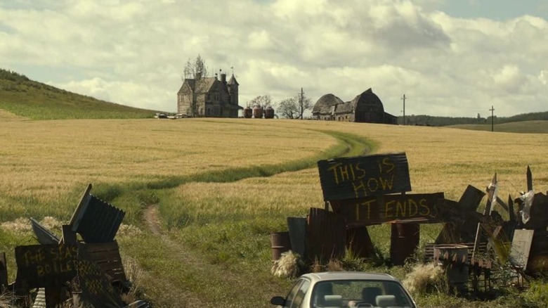 Car driving toward the Spengler farmhouse