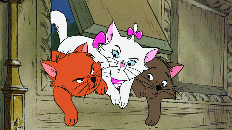 Three kitten squeezing through a cat door in The Aristocats (1970)