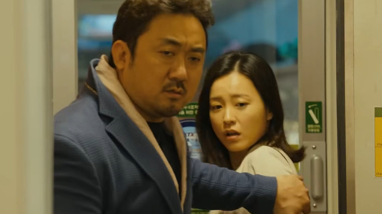 Man and woman on train in Train to Busan