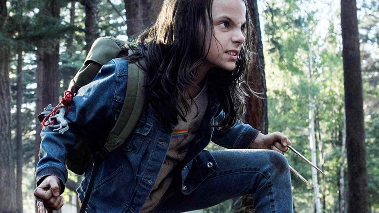 X-23 brandishing her claws in the woods in "Logan"