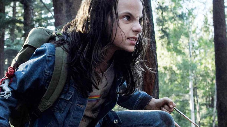 X-23 brandishing her claws in the woods in "Logan"