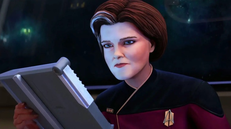 Janeway looks at a PADD