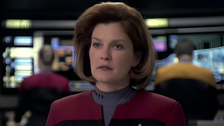 Captain Janeway standing on the bridge of Voyager