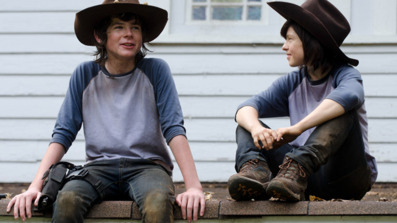 Chandler Riggs and Emily Brobst sitting 
