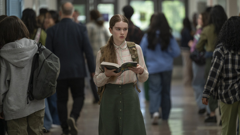 Carrie walking down the school hallway with her book (2026)