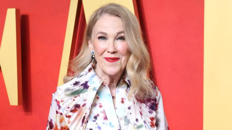 Catherine O'Hara in a patterned top and red lipstick
