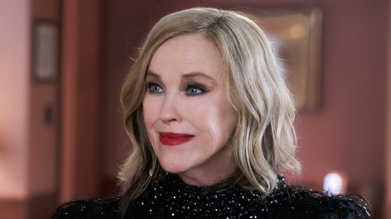 Moira wearing red lipstick and a black sequined top on Schitt's Creek