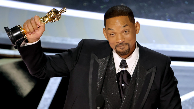 Will Smith onstage holding his Oscar award for 
