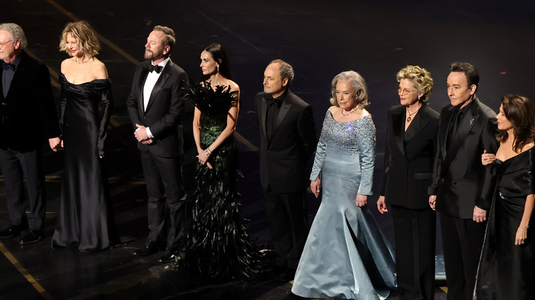 Billy Crystal, Meg Ryan, Kiefer Sutherland, Demi Moore, Kevin Pollak, Kathy Bates, Annette Bening, John Cusack, and Daphne Zuniga standing onstage at the 98th Oscars