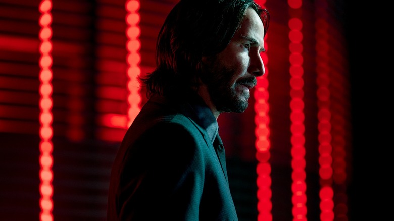 John Wick standing red lights