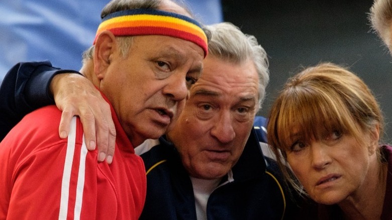 Cheech Marin and Robert De Niro huddling in The War with Grandpa