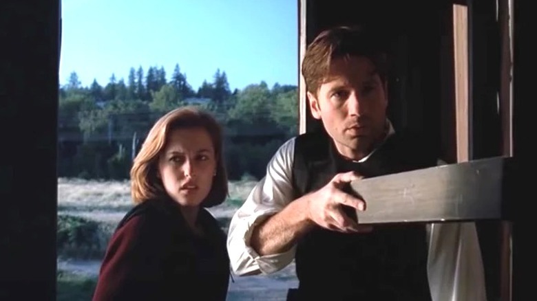 David Duchovny and Gillian Anderson as Mulder and Scully looking worried