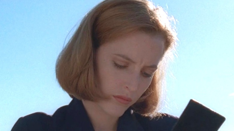Scully writing in notepad