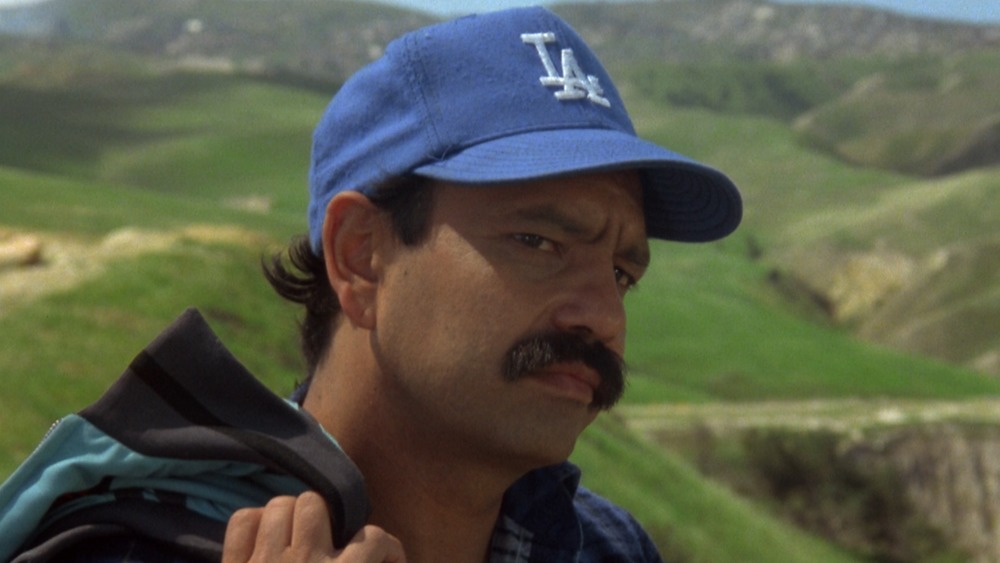 Cheech in Dodgers hat looking pensive