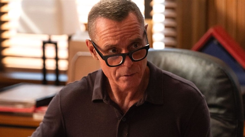 Hank Voight listening at his desk in "Chicago PD"