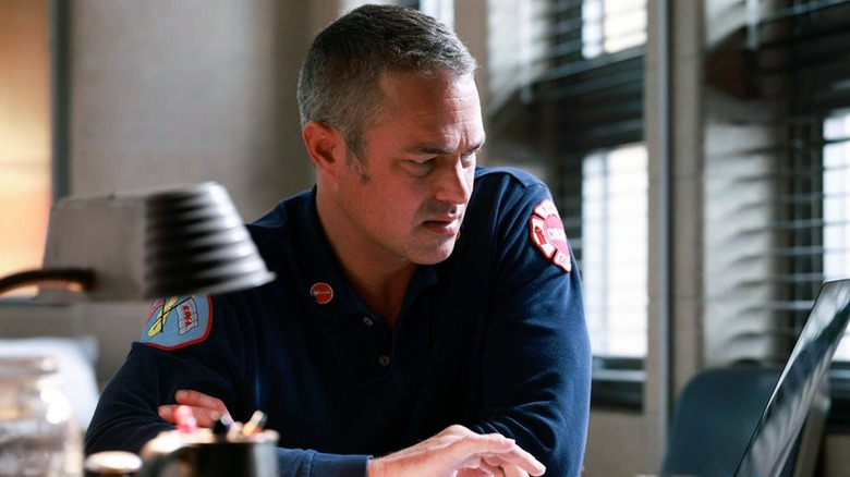 Kelly Severide staring at a laptop computer