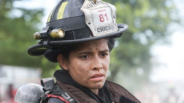 Stella Kidd wearing firefighter's helmet and gear