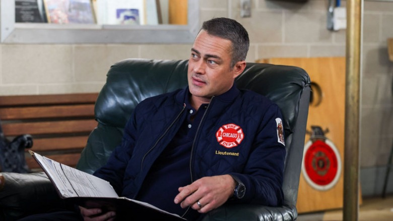 Severide relaxes in an office chair 