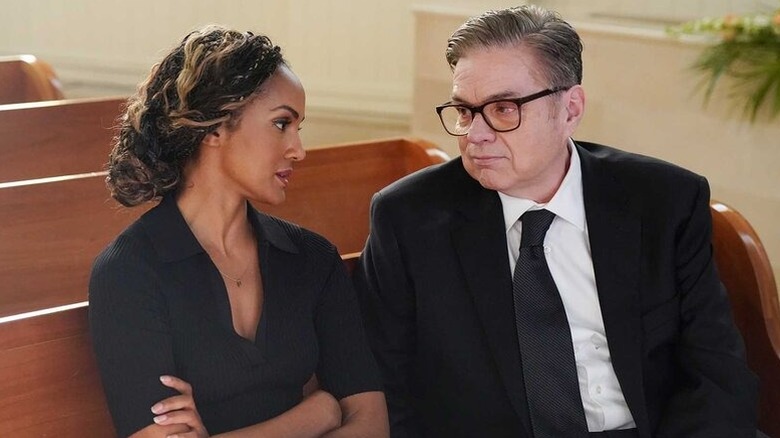 Robin and Daniel Charles talking in a church in 