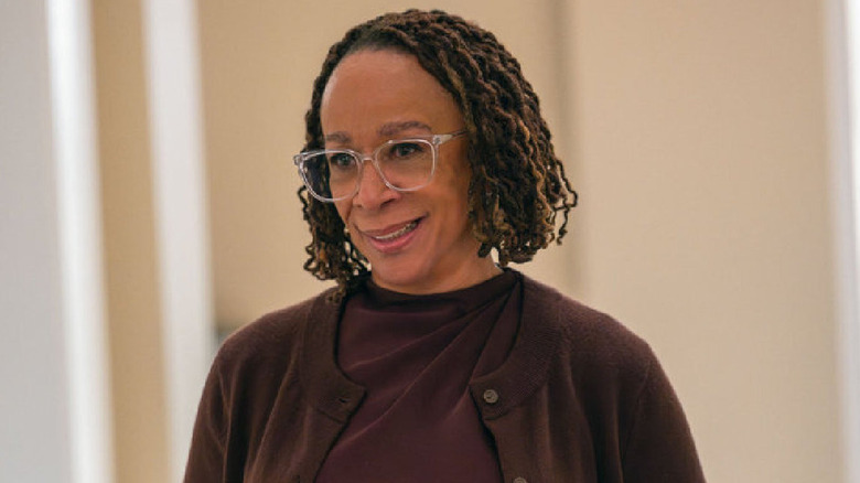 Sharon smiles in a hospital corridor in 