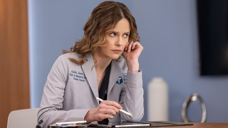 Caitlin listening at a meeting in "Chicago Med"