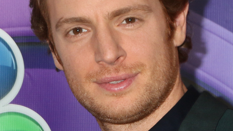 Nick Gehlfuss at event with purple background