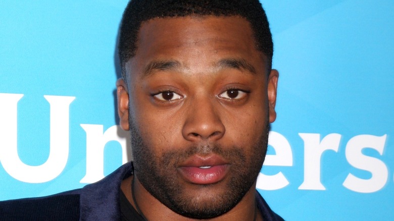 LaRoyce Hawkins in front of a sign
