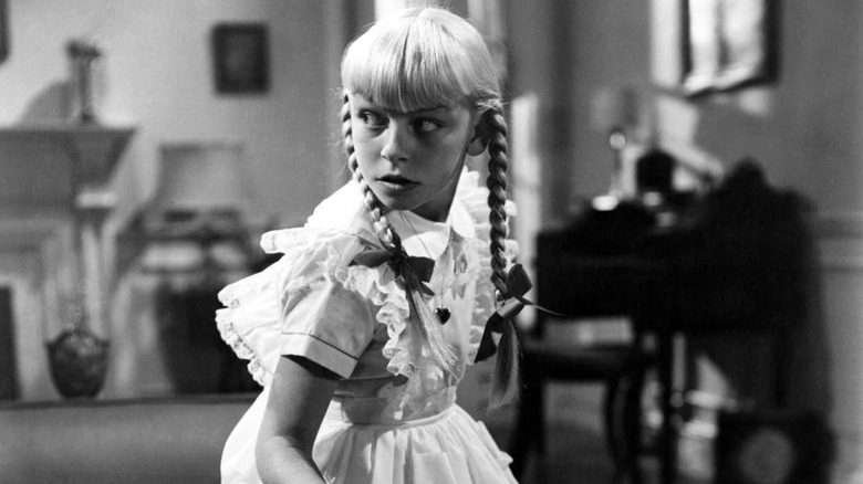 Rhoda looking over her shoulder in The Bad Seed (1956)