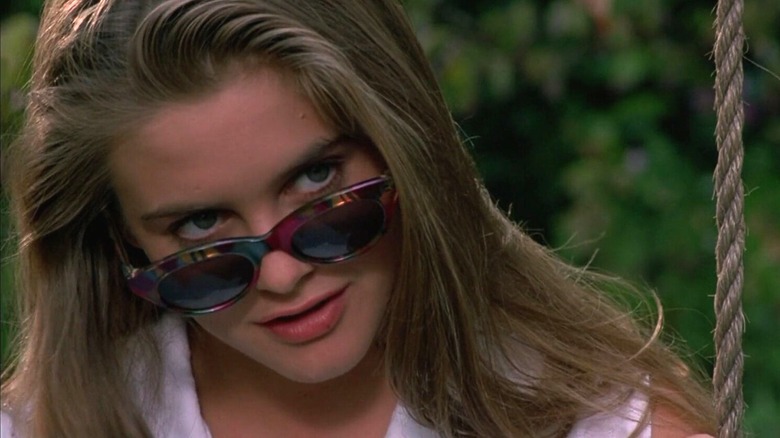 Adrian looks over her sunglasses, smiling, in The Crush (1993)